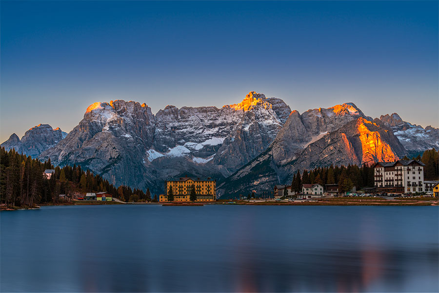 Alpenglow on peaks above Lake Misurina in the Dolomites at sunrise
