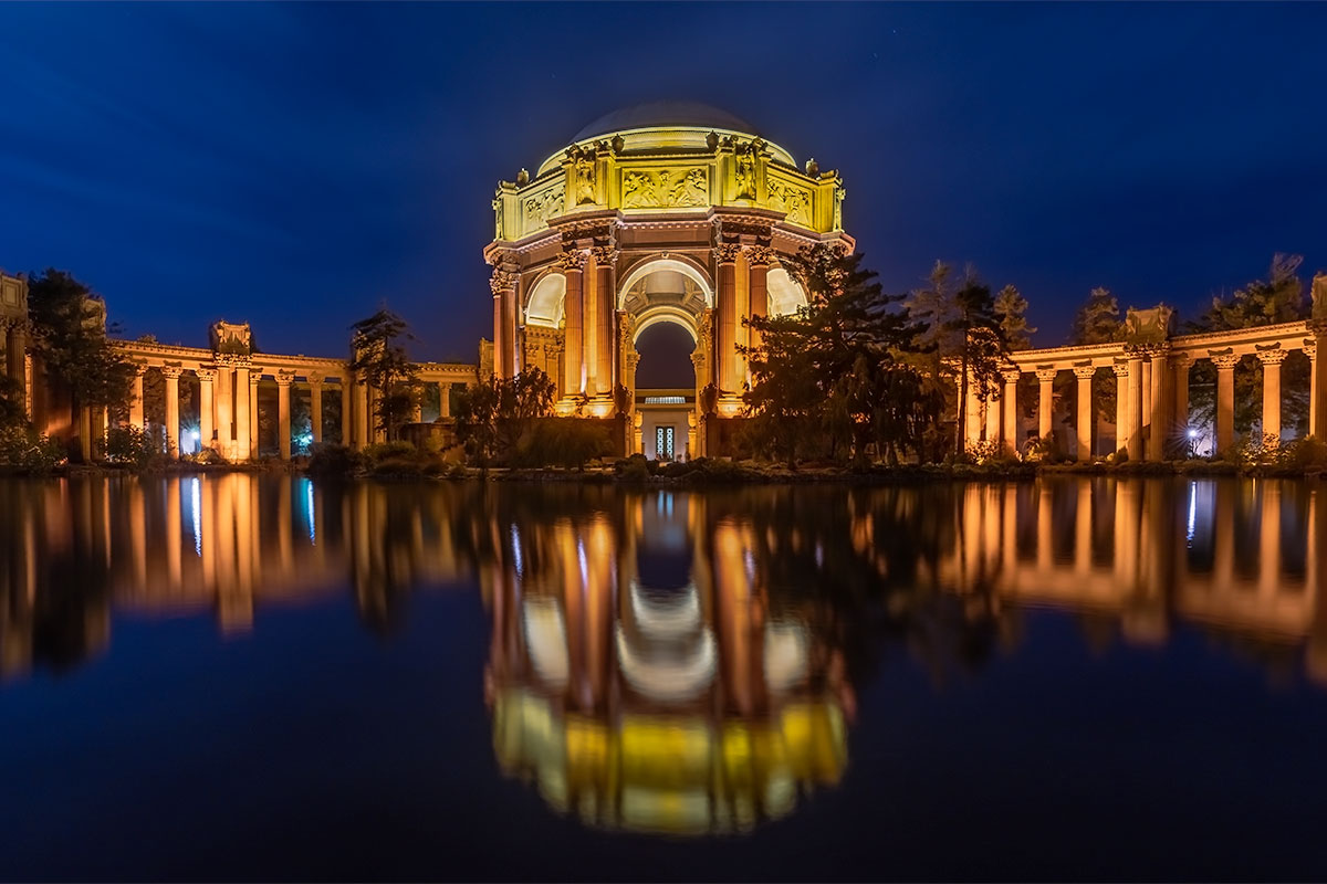 Palace of Fine Arts in San Francisco illuminated at night with reflection in the water